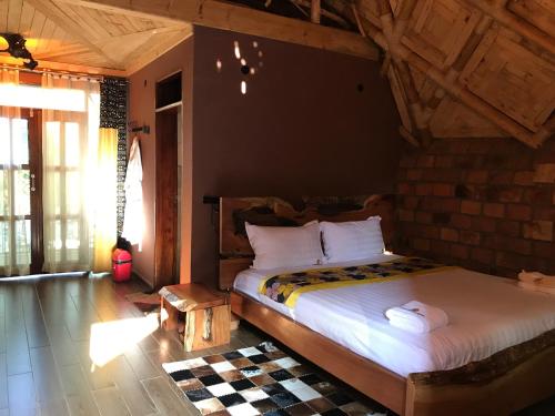 a bedroom with a large bed in a room at Masaka Cultural Resort in Masaka