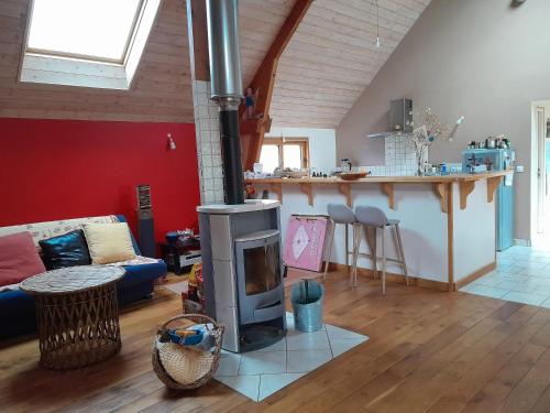 a living room with a stove in the middle of a room at Maison conviviale à Lantic avec jardin de 100 m²_222 in Lantic