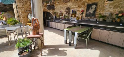 a restaurant with a table and chairs in a room at Maison Fossemagne in Melle
