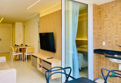 a living room with a television and a table with chairs at Aquarius Style by Holiday Stays in Fortaleza