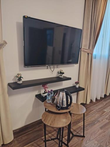 a living room with a tv and a table with a tea kettle at Sada Compound (Women Only) سيدات فقط in Riyadh