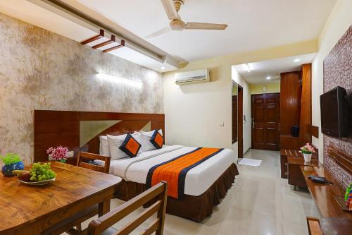 a hotel room with a bed and a dining table at Hotel B Stays in Gurgaon