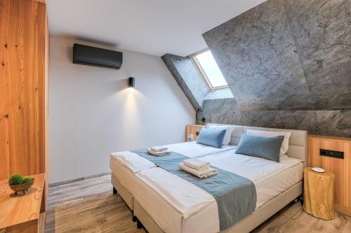 a bedroom with a large bed with blue pillows at Harda House Friends & Spa in Zakopane