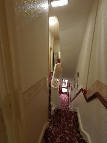 Ένα ή περισσότερα κρεβάτια σε δωμάτιο στο Windsor House Hotel