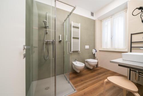 a bathroom with a shower with a toilet and a sink at B&B PIEDICASTELLO in Trento