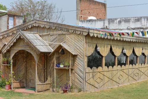 a wooden house with a fence in a yard at Aarambh Residency in Khajurāho