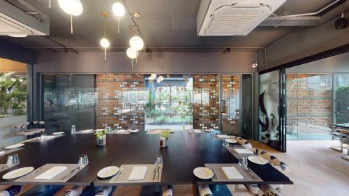 a large dining room with a long table and chairs at Priya Hyderabad in Hyderabad