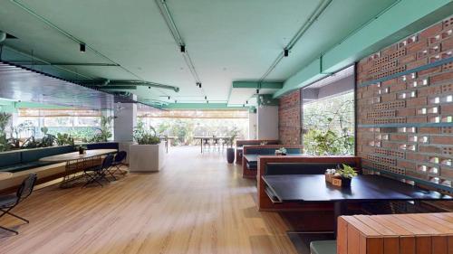 a restaurant with tables and chairs and a brick wall at Priya Hyderabad in Hyderabad