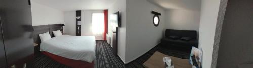 a small bedroom with a bed and a chair at Brit Hotel Reims La Neuvillette in Reims