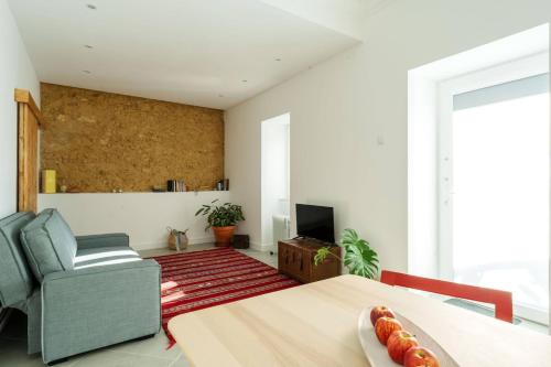 a living room with a table and a couch at Palmela 33 - in the Heart of Historic Center in Palmela
