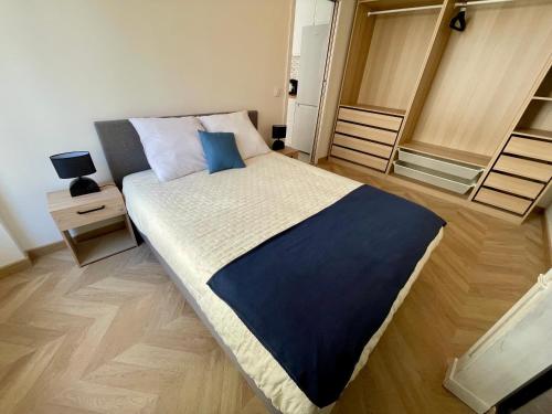 a bedroom with a large bed with blue pillows at Appartement Convention Maridor 3 in Paris