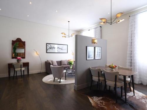 a living room with a table and chairs and a couch at Adara Palmiet Valley Luxurious Boutique Farm Hotel in Paarl