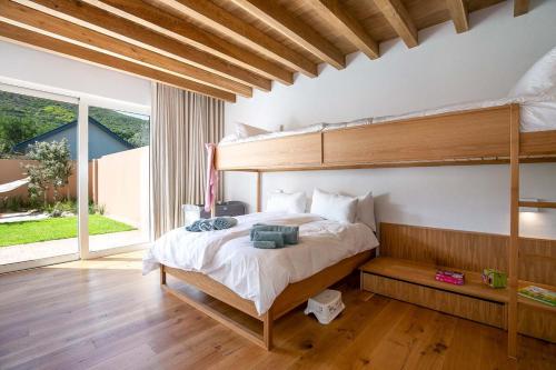 a bedroom with a bunk bed and a large window at Noordhoek Sunset Villa in Flat Acres