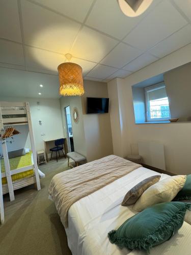 a bedroom with a large bed in a room at Cit'Hotel Les Alizes in Dinard