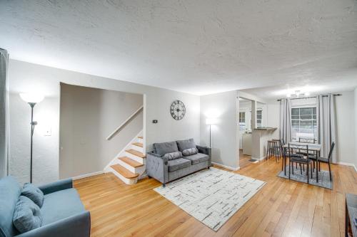 a living room with a couch and a table at 2 Mi to Lake Erie Home with Yard in Euclid! in Euclid
