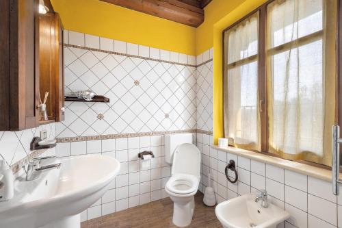 a bathroom with a white toilet and a sink at Fattoria Delle Vignole in Sommariva Perno