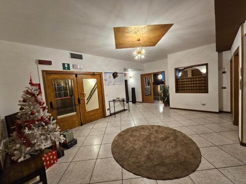 a living room with a christmas tree in the middle at TEA San Pellegrino - DOLOMITI in Falcade