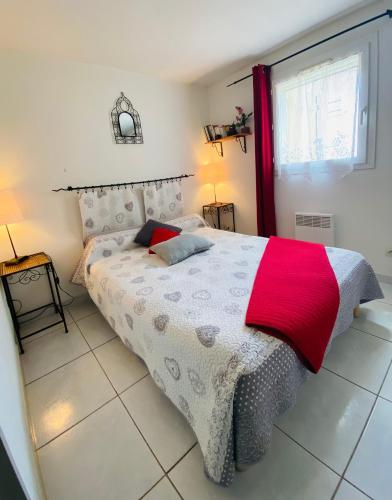 une chambre avec un lit avec une couverture rouge dessus dans l'établissement Jolie Villa 6 pers terrasse et Parking 400 m plage - V0736, à Vias
