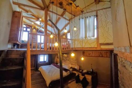 a bedroom with a loft bed and a bed in a room at ArtVillage Naggar - Entire Katkuni Villa in Nagar