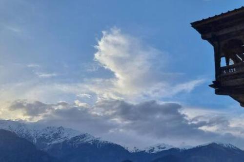 a cloudy sky with mountains in the background at ArtVillage Naggar - Entire Katkuni Villa in Nagar