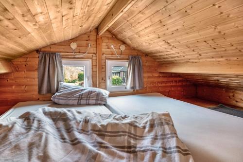 a bedroom with a bed in a log cabin at Ferienhaus Thomsen in Groß Olversum