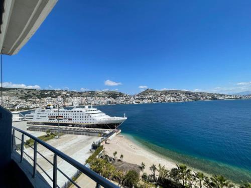 a cruise ship is docked at a beach at Kristina Bellavista Rooms in Sarandë