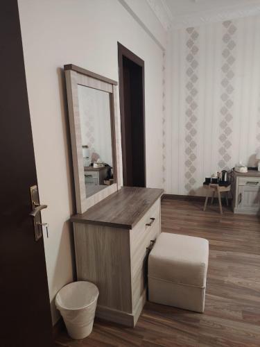 a bathroom with a vanity with a mirror and a stool at Sada Compound (Women Only) سيدات فقط in Riyadh