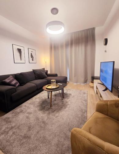 a living room with a couch and a table at Crown Hall Suites in Limassol