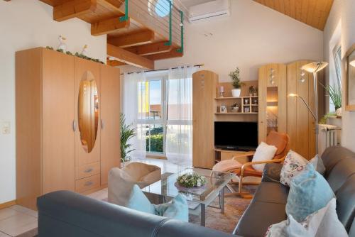 a living room with a couch and a table at Ferienwohnung Lang, 45qm in Sasbach am Kaiserstuhl
