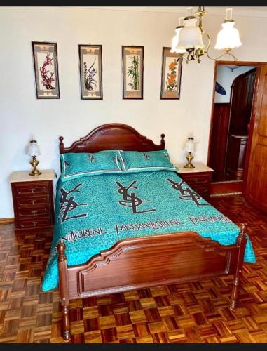 a bedroom with a bed with a blue blanket on it at Spray B&B Sitio in Nazare, European style in Nazaré