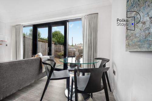 a living room with a glass table and chairs at The Stables, Chester - Luxury Apartments by PolkaStays in Chester