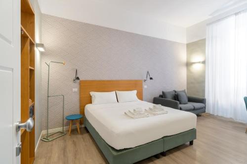 a bedroom with a large bed and a chair at Napoli Visit Home in Naples