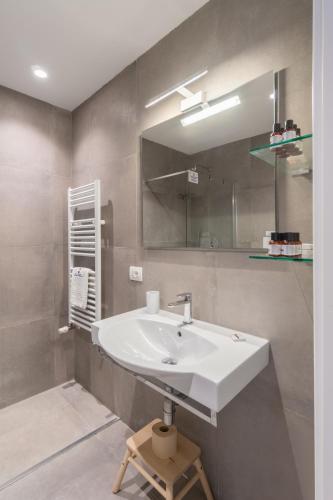 a bathroom with a white sink and a mirror at Napoli Visit Home in Naples
