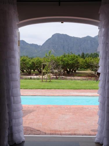 a view of a pool through an open window at Adara Palmiet Valley Luxurious Boutique Farm Hotel in Paarl