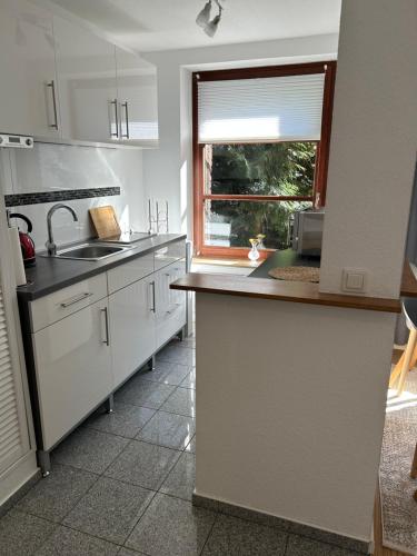 a kitchen with a sink and a window at Wohnung mit Stellplatz, WLAN, Netflix in Krefeld