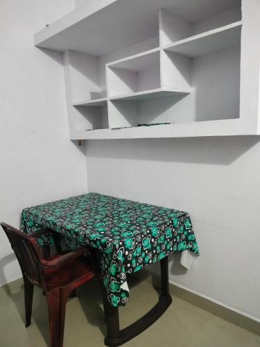 a small table with a green and white table cloth on it at Aswathy Bhavan in Vadakkāncheri