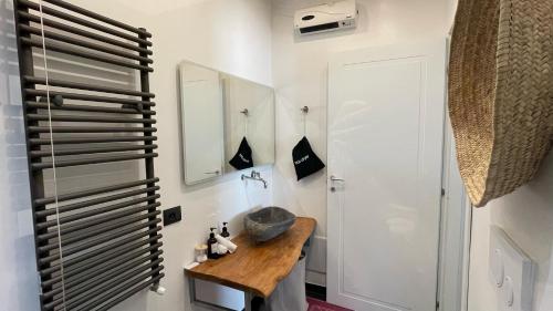a bathroom with a sink and a mirror at KeRo Luxury Rooms in Cagliari