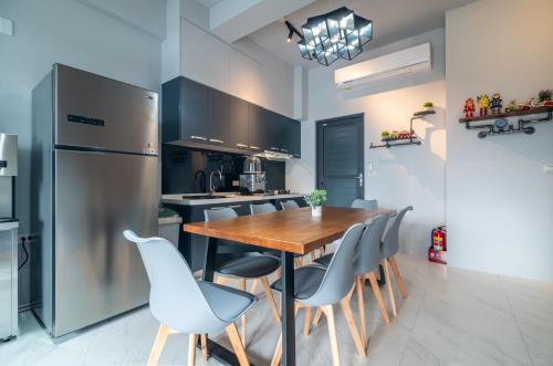 a kitchen with a wooden table and chairs and a refrigerator at No 79 Corner Villa in Jiaoxi