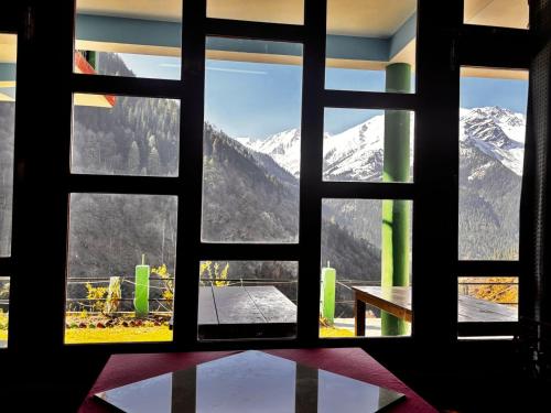 a window with a view of a snowy mountain at Snow View Guest House in Kulu