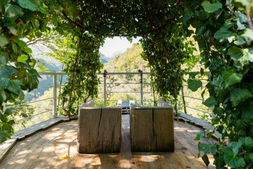 two wooden benches sitting on top of a wooden deck at Medieval Tower In Sibillini Mountains Park in Vetice