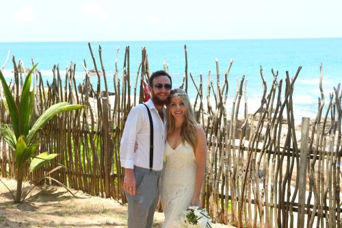 a bride and groom posing for a picture on the beach at Turtle Bay Boutique Hotel in Tangalle