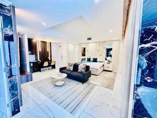 a living room with a couch and a bed at H & H Boutique & SPA in Roodepoort