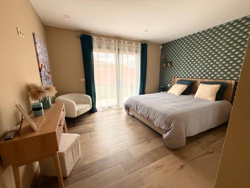 a bedroom with a bed and a desk and a window at Casa Julia in Vila Nova de Cerveira