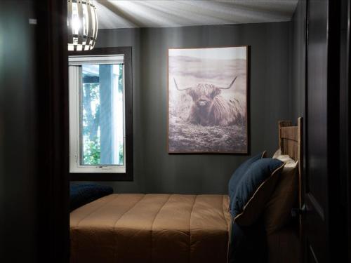 a bedroom with a picture of a bull on the wall at Birch Bay in Nisswa