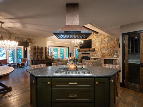 a kitchen with a stove and a living room at Birch Bay in Nisswa
