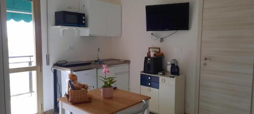 a small kitchen with a table and a counter top at La casa di Mariconcy in Bologna