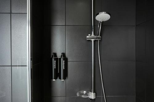 a shower with a shower head in a bathroom at The Social Hub Madrid Extended Stay in Madrid