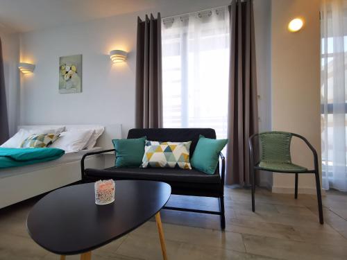 a living room with a couch and a table at MIKA Studios in Eforie Nord