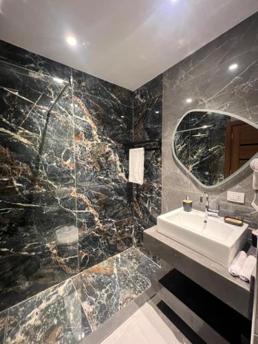 a bathroom with a sink and a mirror at Villa KUBA luxury in Hurghada