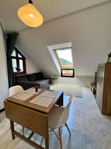 a kitchen and dining room with a table and chairs at Atico en Tina Mayor in Unquera